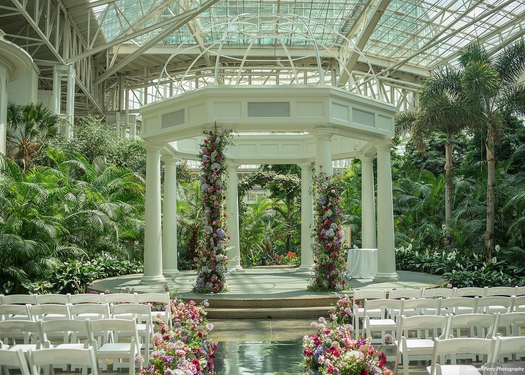 Lush floral installation in a bright spring color palette including the Pantone 2022 color of the year Very Peri. Featured florals: garden roses, hydrangea and lush greenery. Nashville wedding florist at Gaylord Opryland.