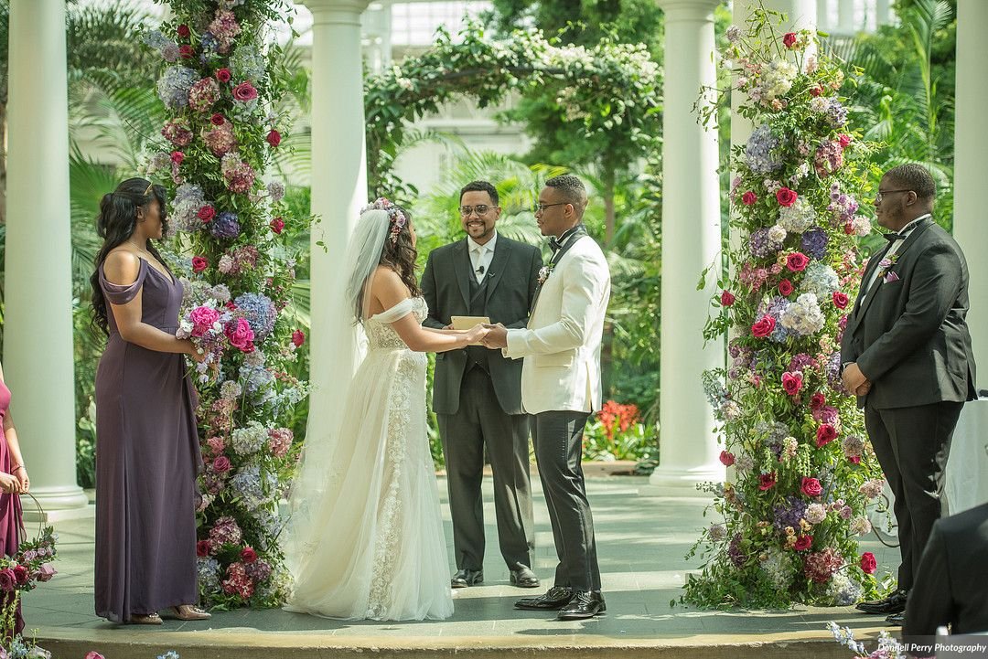 Lush floral installation in a bright spring color palette including the Pantone 2022 color of the year Very Peri. Featured florals: garden roses, hydrangea and lush greenery. Nashville wedding florist at Gaylord Opryland.