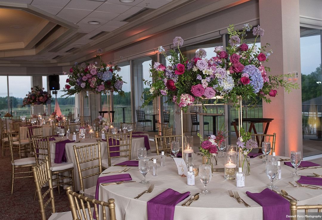 Bright floral centerpiece in berry hues featuring garden roses, hydrangea and lush greenery. Nashville wedding florist at Gaylord Opryland.
