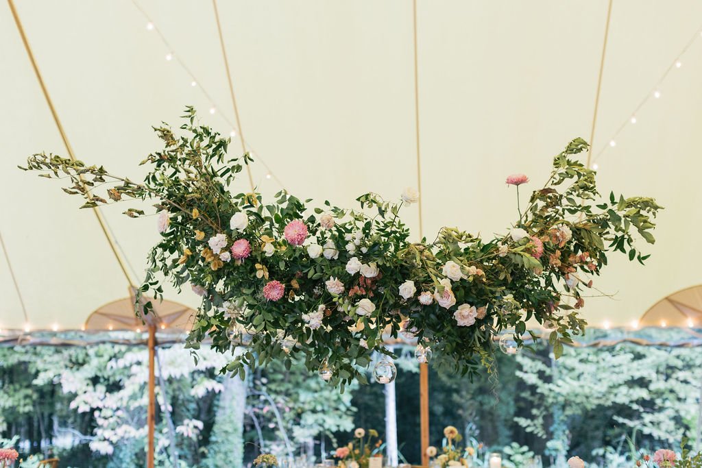 Autumn inspired hanging floral installation featuring lush natural greenery and roses. Nashville wedding florist at RT Lodge.