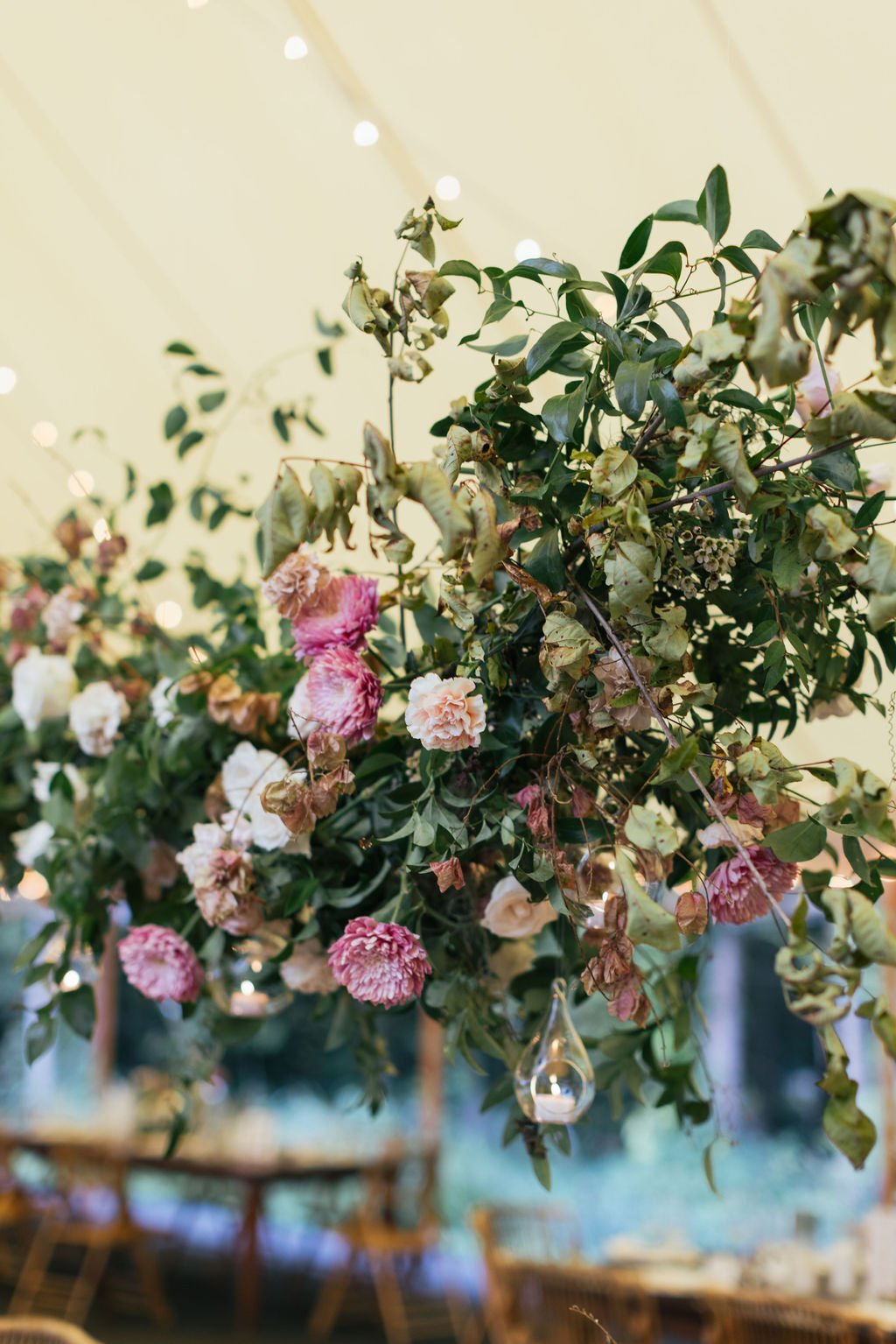 Autumn inspired hanging floral installation featuring lush natural greenery and roses. Nashville wedding florist at RT Lodge.