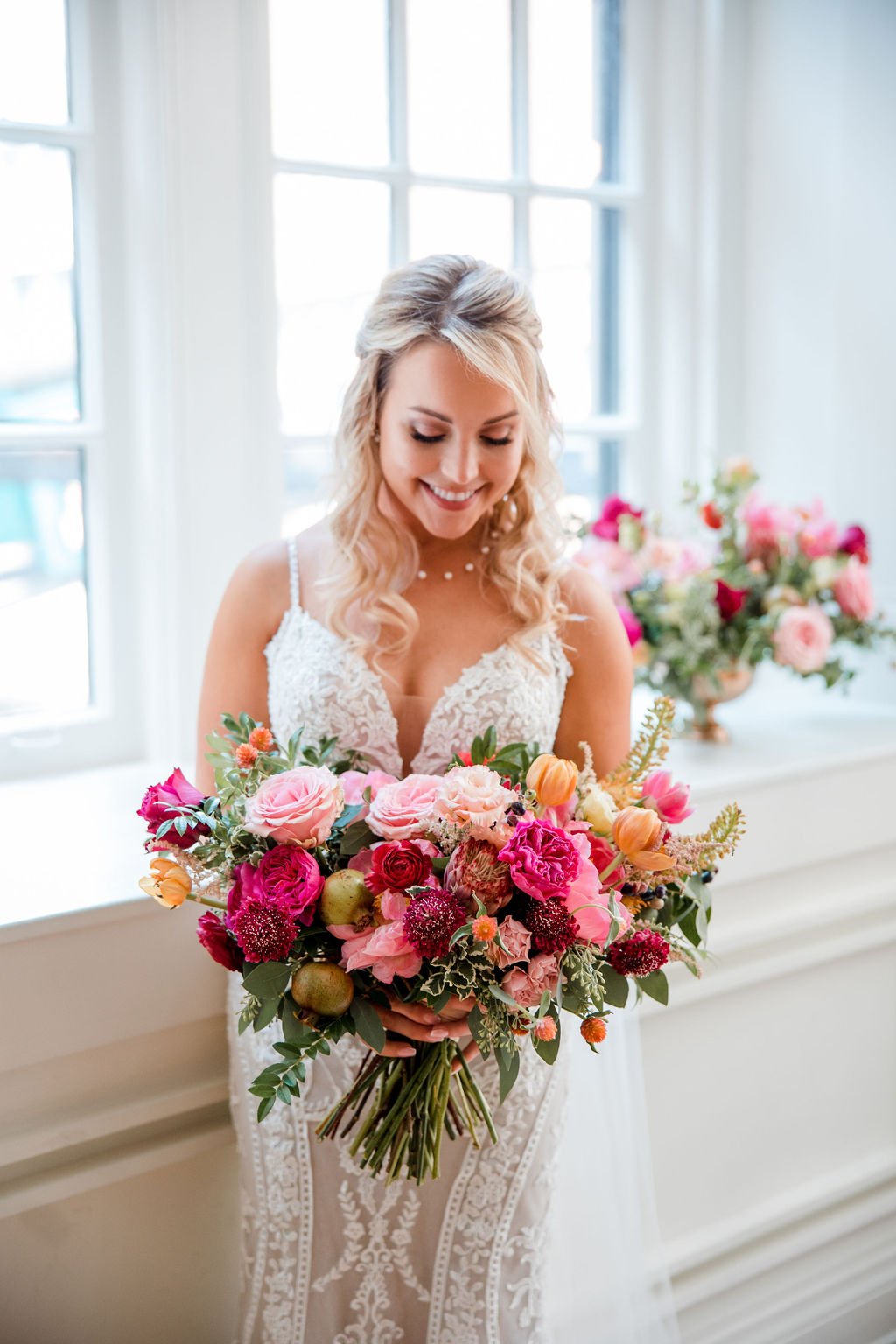 Lush and artful bridal bouquet with textural accents. Balanced color palette of pinks, oranges and muted burgundy tones featuring garden roses, peonies, ranunculus and tulips. Nashville wedding florist at Hotel Noelle.