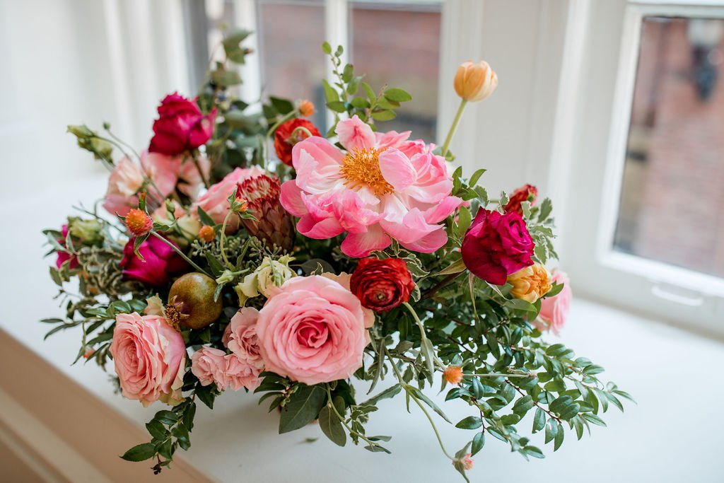 Romantic floral centerpiece with jewel tone flowers and textural elements including garden roses, peonies, ranunculus, tulips and natural greenery. Nashville wedding florist at Hotel Noelle.