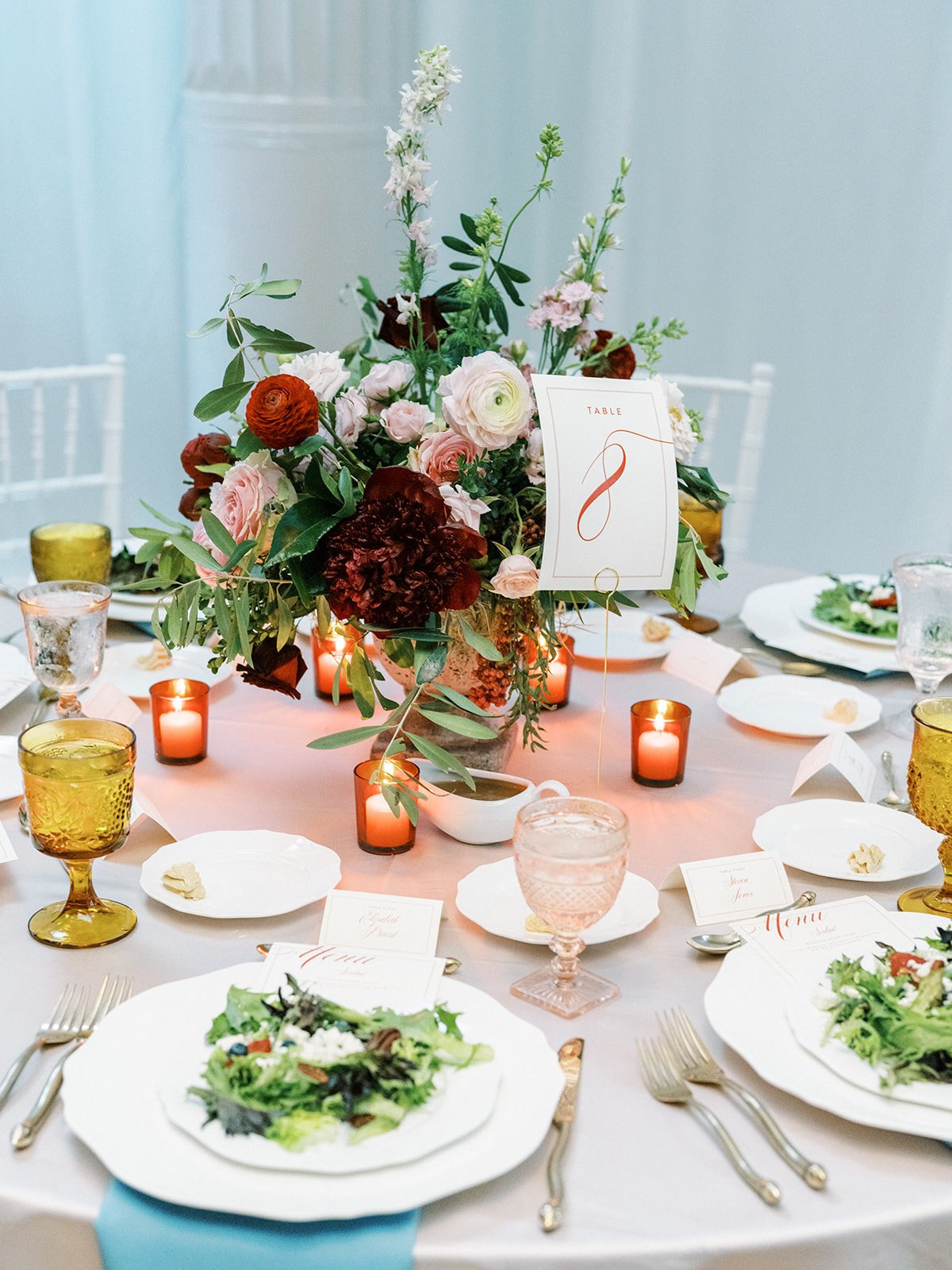 Beautiful reception adorned with marble busts covered in florals and lush centerpieces. The summer solstice color palette was filled with garden roses, peonies, ranunculus, pepper berry and fresh fruit. Design by Rosemary and Finch in Nashville, TN.