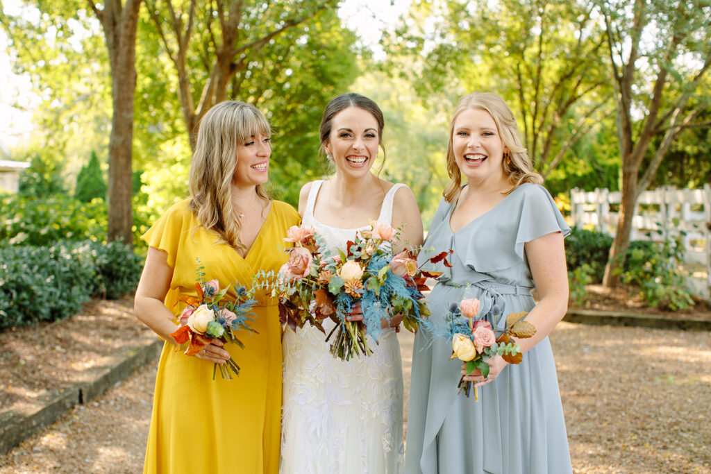 Dainty bridal party florals featuring hues of mustard yellow, dusty rose, sage green, dusty blue, and terra cotta. Fall florals comprised of ranunculus, tulips, garden rose, thistle, ferns, thistle, and eucalyptus. Designed by Rosemary and Finch in Nashville, TN.