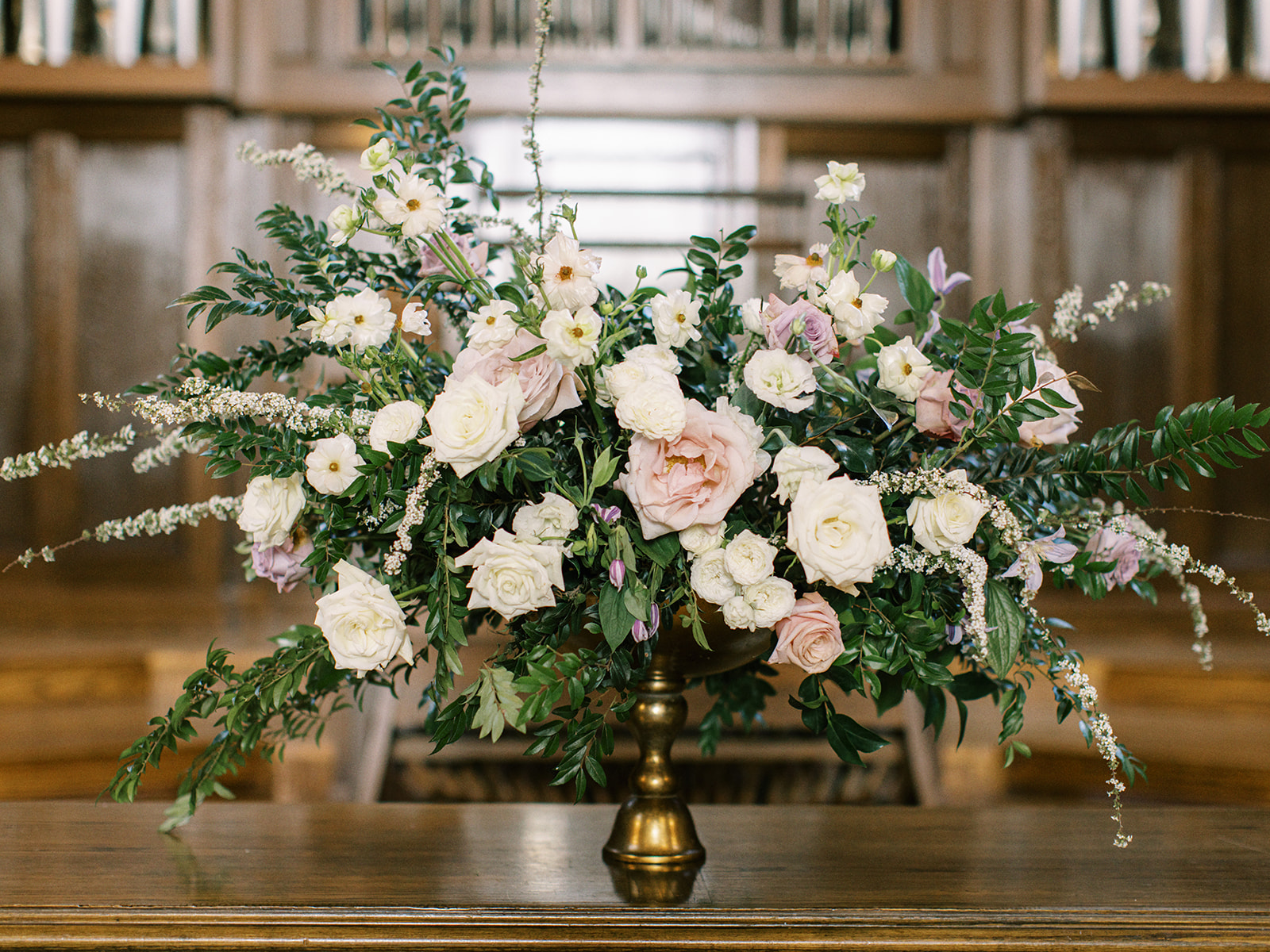 Spring cathedral wedding in the Scarritt Bennett Center in downtown Nashville, TN. Classic floral accents of garden urns and aisle markers in hues of white, green, cream, mauve, and lavender featuring roses, peonies, ranunculus, clematis, and spirea. Design by Rosemary and Finch Floral Design in Nashville, TN. 