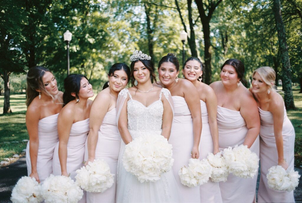 Classic white bridal party bridesmaid’s bouquets of large white peonies are the perfect touch to this summer wedding. Design by Rosemary and Finch Floral Design in Nashville, TN at Cherokee Dock.