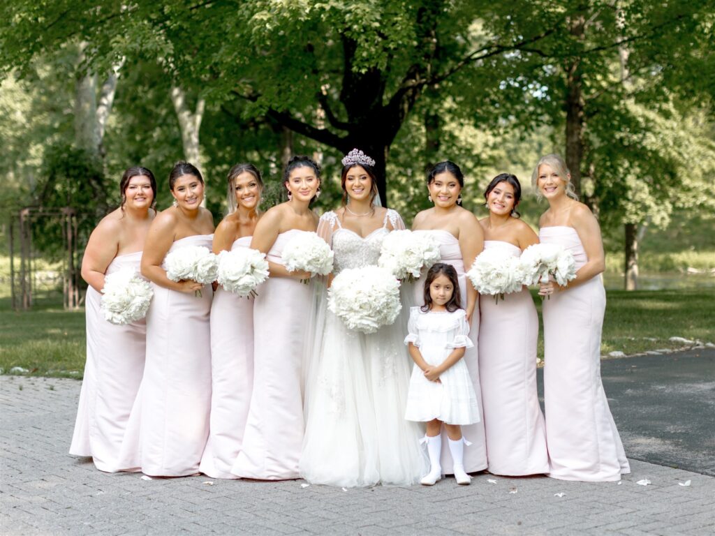 Classic white bridal party bridesmaid’s bouquets of large white peonies are the perfect touch to this summer wedding. Design by Rosemary and Finch Floral Design in Nashville, TN at Cherokee Dock.
