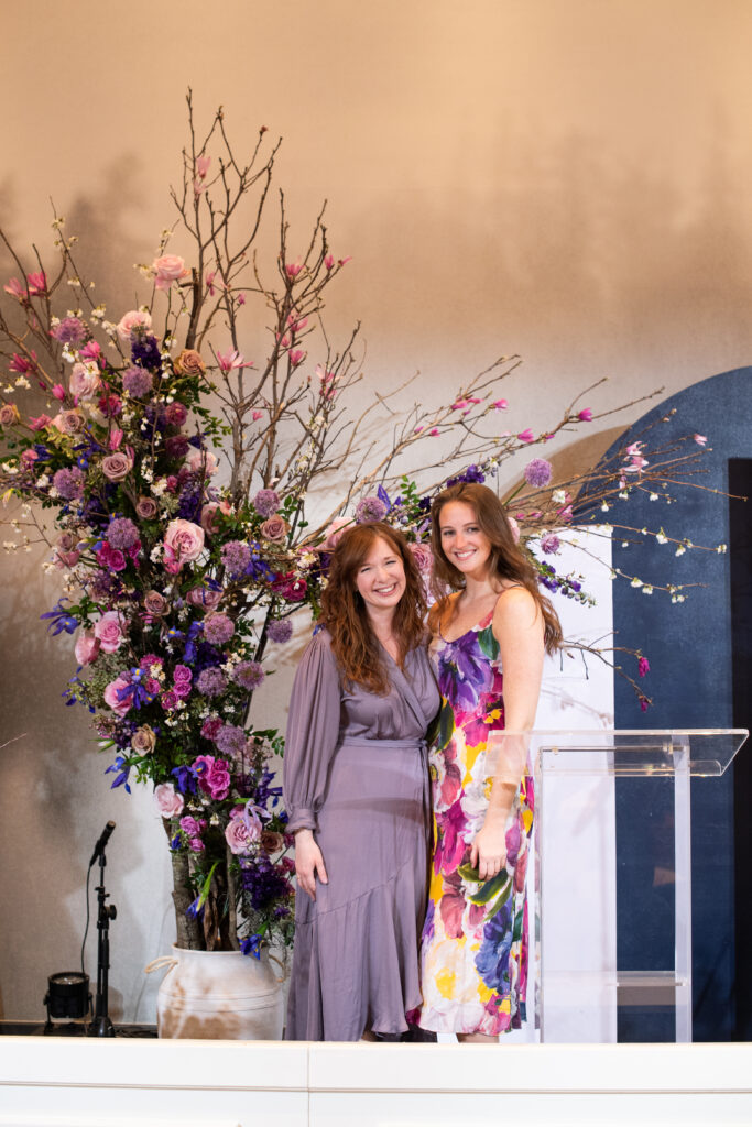 Stunning spring floral tree installation for WIPA Nashville Town Hall highlighted by purple TN Irises, dusty pink roses, purple allium, and blooming spring branches. Corporate industry event florals in Downtown Nashville. Design by Rosemary and Finch Floral Design in Nashville, TN.