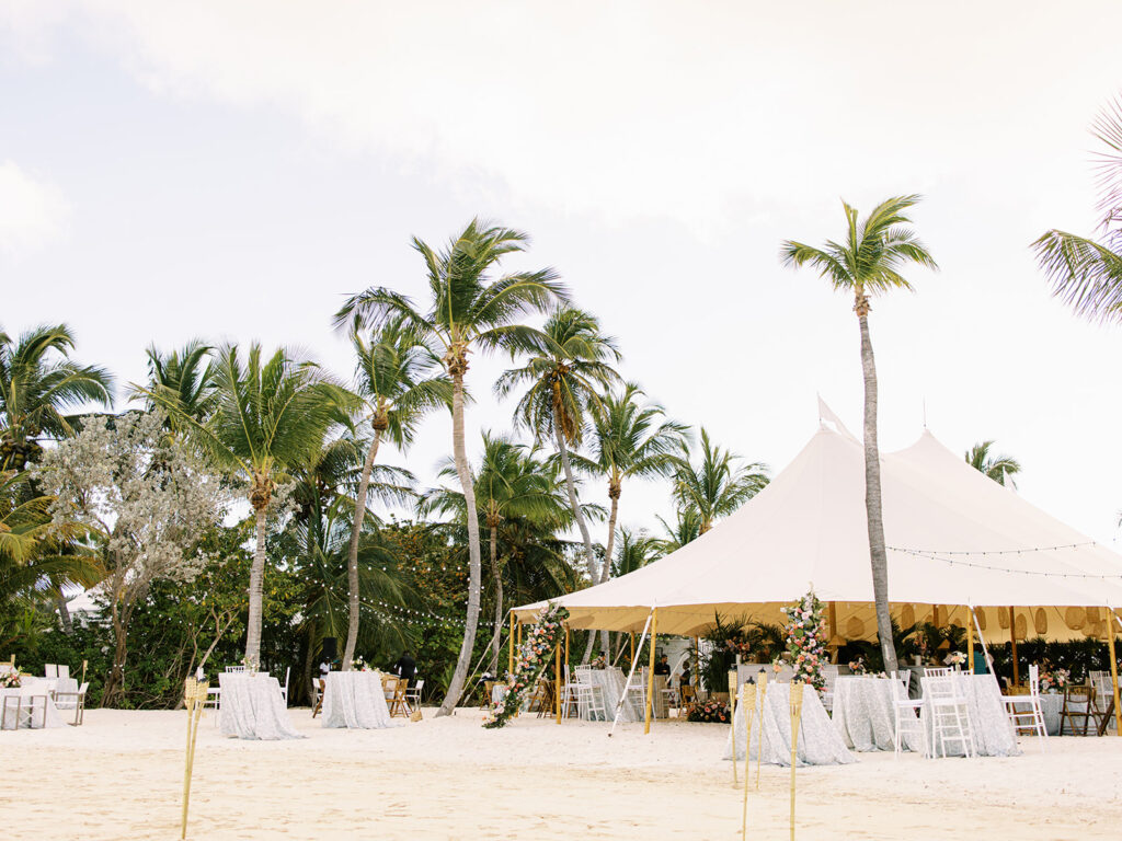 Spring destination beach front private estate wedding in Exuma, Bahamas complete with tropical floral design in pink, peach, mauve, light blue, pale yellow, lavender, and cream colors. Destination floral designer utilizing roses, orchids, ginger, and tropical foliage. Design by Rosemary & Finch Floral Design. 