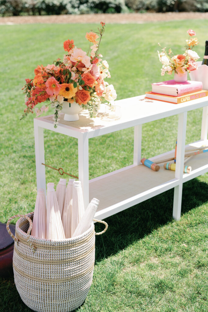 Vibrant floral accents for croquet themed cocktail hour. Spring beach wedding with floral colors in tangerine, peach, coral, orange, cream, and blush. Bridal photoshoot with destination beach floral design at The Ritz-Carlton Amelia Island. Destination floral design by Rosemary & Finch Floral Design. 