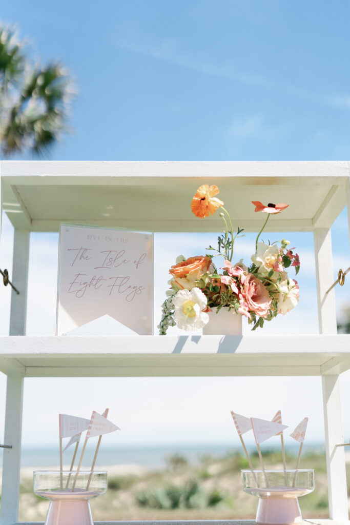 Vibrant floral accents for croquet themed cocktail hour. Spring beach wedding with floral colors in tangerine, peach, coral, orange, cream, and blush. Bridal photoshoot with destination beach floral design at The Ritz-Carlton Amelia Island. Destination floral design by Rosemary & Finch Floral Design. 
