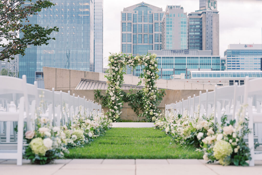 Garden-inspired floral aisle markers for summer wedding. Classic white and green wedding with timeless garden-inspired floral design. Ceremony aisle florals for summer wedding in downtown Nashville. Design by Rosemary & Finch Floral Design in Nashville, TN. 