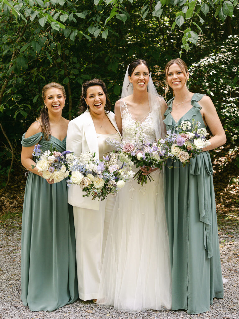 Lush whimsical bridal bouquets with garden-inspired floral design. Flowers in colors of lavender, purple, dusty blue, cream, mauve, and natural greenery. Spring wedding bridal bouquet florals consisting of roses, delphinium, tweedia, and ranunculus. Design by Rosemary & Finch Floral Design in Nashville, TN.