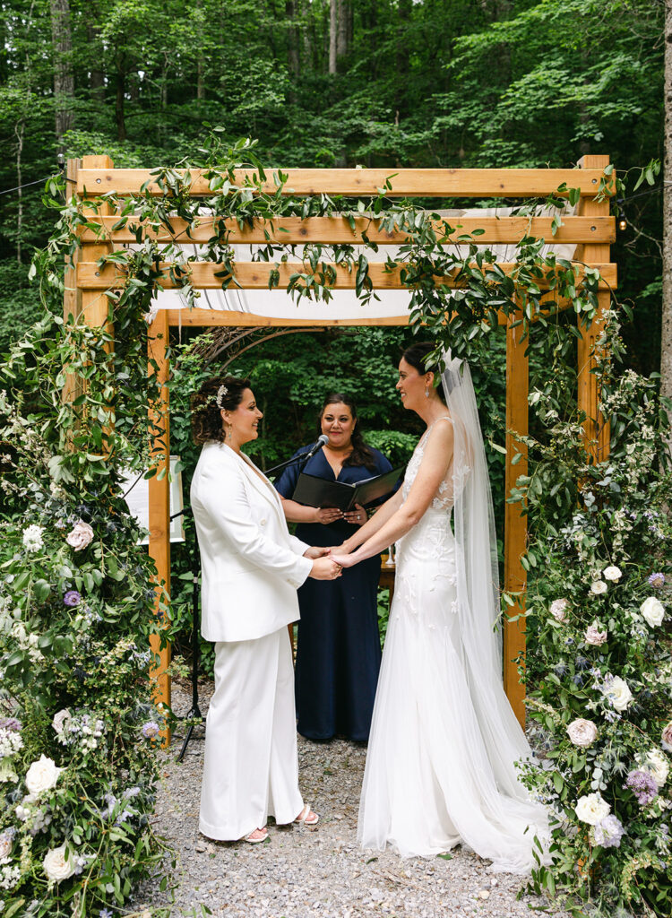 Whimsical spring wedding in Tennessee countryside with flower colors in lavender, purple, cream, mauve, and natural green. Garden-inspired floral design for ceremony chuppah with natural growing greenery, roses, and delphinium. Design by Rosemary & Finch Floral Design in Nashville, TN. 