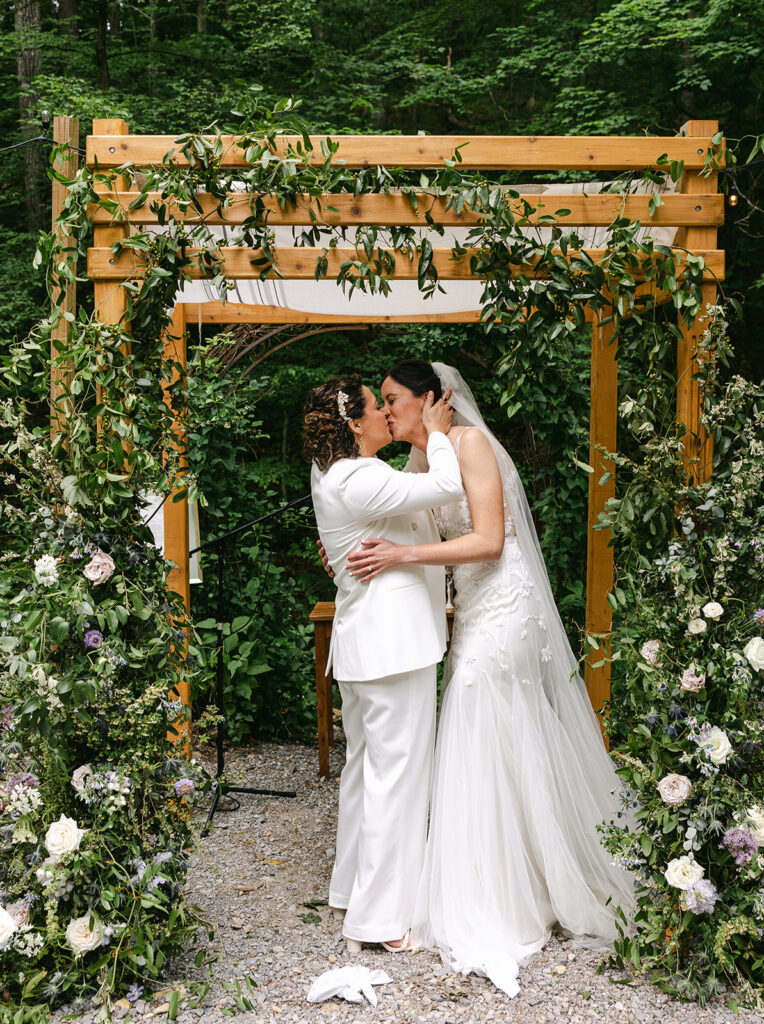 Whimsical spring wedding in Tennessee countryside with flower colors in lavender, purple, cream, mauve, and natural green. Garden-inspired floral design for ceremony chuppah with natural growing greenery, roses, and delphinium. Design by Rosemary & Finch Floral Design in Nashville, TN. 