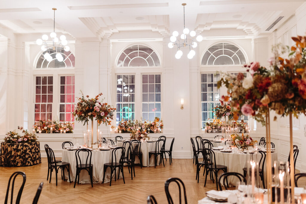 Autumnal beauty covers this Parisian inspired fall wedding in florals composed of roses, lisianthus, ranunculus clematis, copper beech, raintree pods, mums, and fall foliage creating rich fall colors of dusty rose, terra cotta, burgundy, lavender, and copper. Fall wedding in Downtown Nashville. Design by Rosemary & Finch Floral Design in Nashville, TN. 