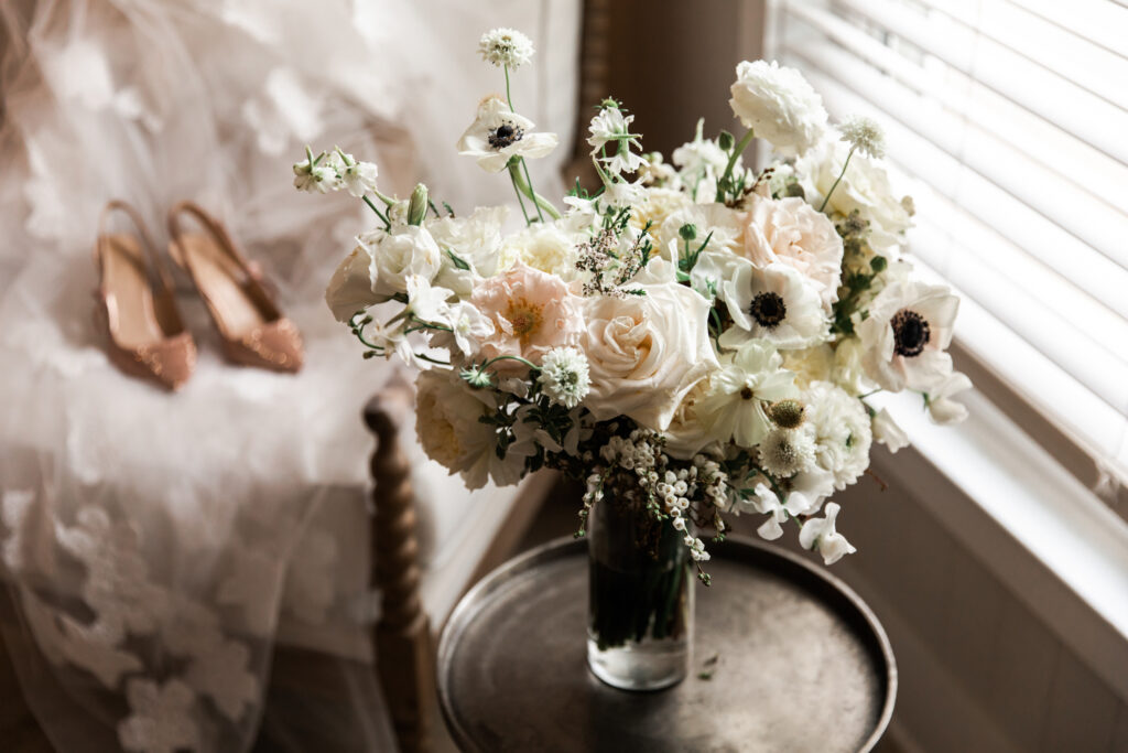 Timeless bridal bouquet with anemones, roses, sweet peas, and ranunculus for fall wedding. Classic floral design with cream, white, and blush flowers. Fall destination wedding outside Nashville, TN. Design by Rosemary & Finch Floral Design. 