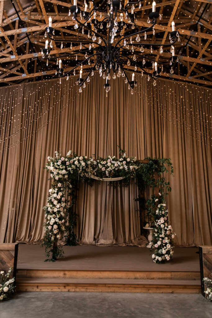 Timeless chuppah floral design for fall wedding ceremony and reception in Nashville, TN. Timeless floral colors in white, cream, and blush. Growing organic floral design for chuppah with roses and natural greenery. Destination wedding floral design. Design by Rosemary & Finch Floral Design in Nashville, TN. 