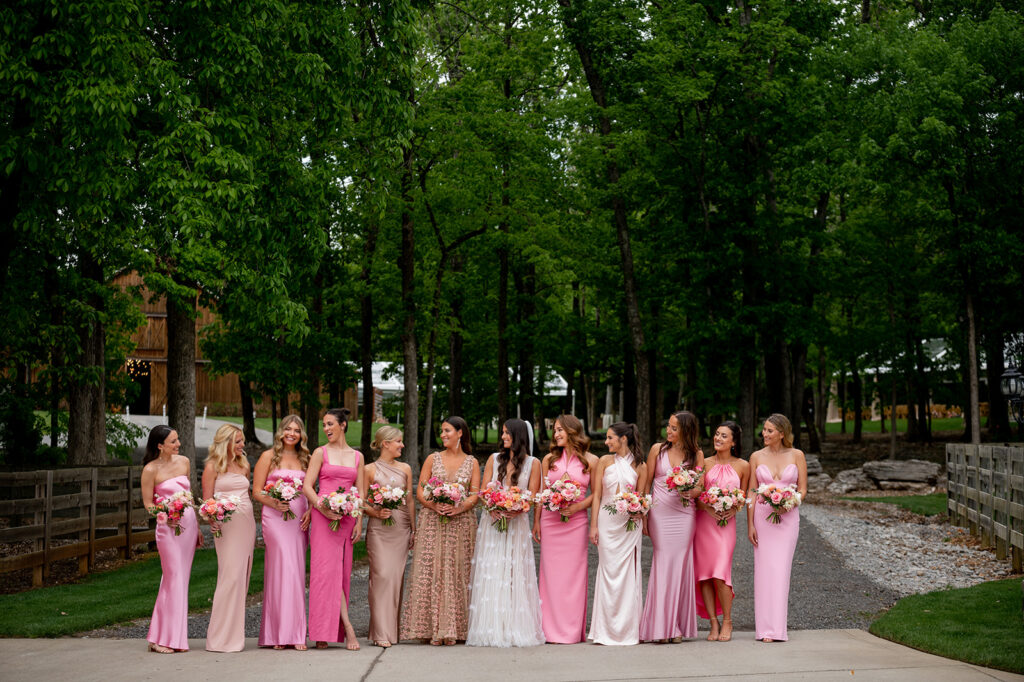 Floral heavy pink bridesmaids’ bouquets featuring peak spring blooms. Bouquet featuring peonies, tulips, ranunculus, butterfly ranunculus, and rose flowers in pink, blush, white, and peach colors. Pink spring wedding outside Nashville, TN. Design by Rosemary & Finch Floral Design in Nashville, TN. 