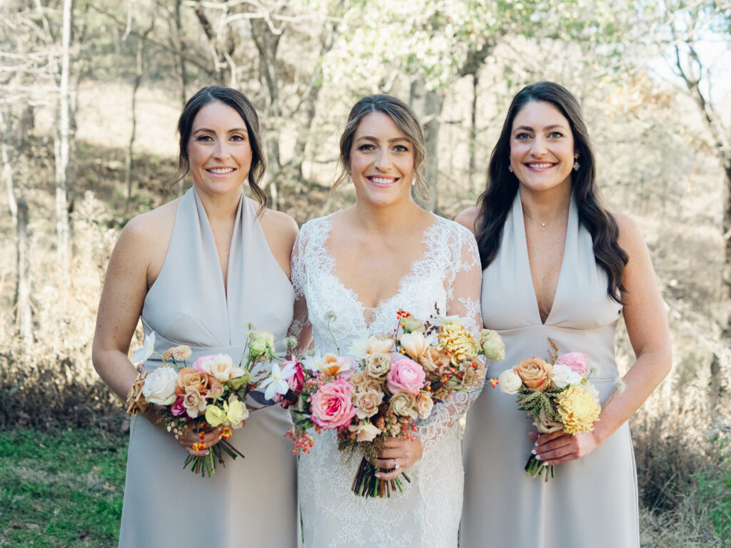 Whimsical bridesmaids’ bouquets in unique fall tones caramel, dusty rose, peach, tangerine, and copper. Fall floral bouquet with roses, ranunculus, mums, fruiting branches, and clematis. Medium sized bridal bouquet with fall colors. Destination wedding outside Nashville, TN. Design by Rosemary & Finch Floral Design in Nashville, TN. 