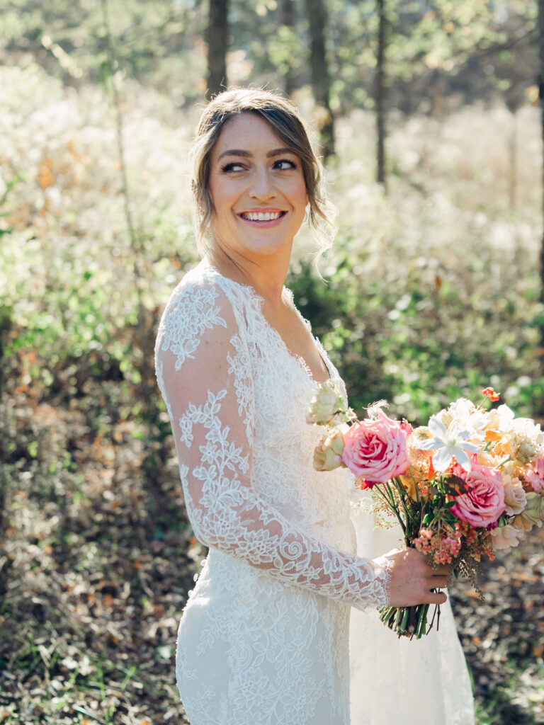 Whimsical bridal bouquet in unique fall tones caramel, dusty rose, peach, tangerine, and copper. Fall floral bouquet with roses, ranunculus, mums, fruiting branches, and clematis. Medium sized bridal bouquet with fall colors. Destination wedding outside Nashville, TN. Design by Rosemary & Finch Floral Design in Nashville, TN. 