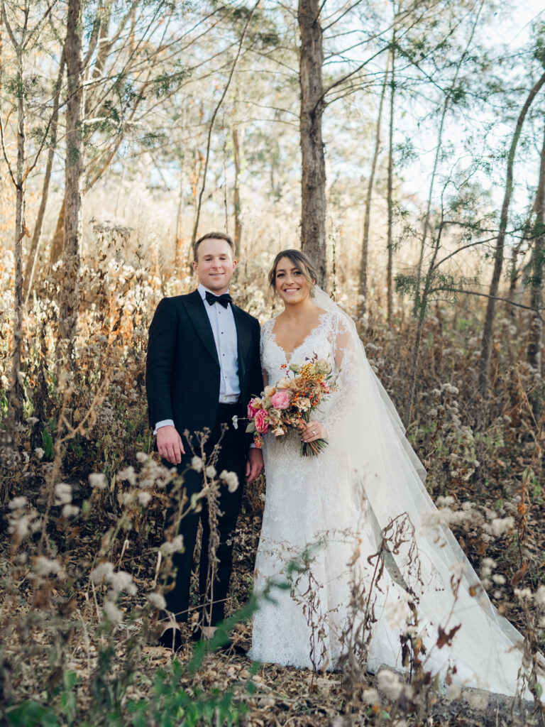 Whimsical bridal bouquet in unique fall tones caramel, dusty rose, peach, tangerine, and copper. Fall floral bouquet with roses, ranunculus, mums, fruiting branches, and clematis. Medium sized bridal bouquet with fall colors. Destination wedding outside Nashville, TN. Design by Rosemary & Finch Floral Design in Nashville, TN. 