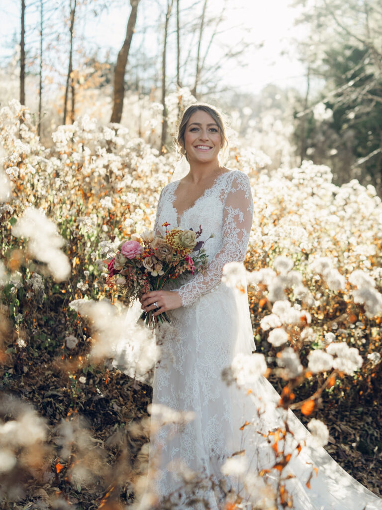 Whimsical bridal bouquet in unique fall tones caramel, dusty rose, peach, tangerine, and copper. Fall floral bouquet with roses, ranunculus, mums, fruiting branches, and clematis. Medium sized bridal bouquet with fall colors. Destination wedding outside Nashville, TN. Design by Rosemary & Finch Floral Design in Nashville, TN. 