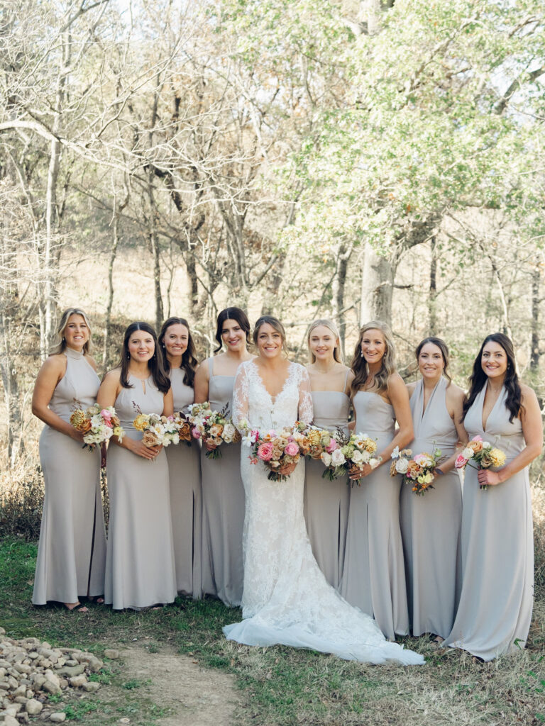 Whimsical bridesmaids’ bouquets in unique fall tones caramel, dusty rose, peach, tangerine, and copper. Fall floral bouquet with roses, ranunculus, mums, fruiting branches, and clematis. Medium sized bridal bouquet with fall colors. Destination wedding outside Nashville, TN. Design by Rosemary & Finch Floral Design in Nashville, TN. 