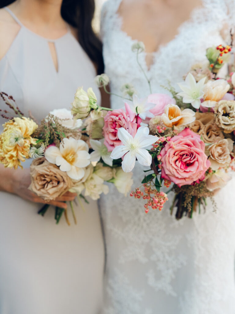 Whimsical bridal bouquet in unique fall tones caramel, dusty rose, peach, tangerine, and copper. Fall floral bouquet with roses, ranunculus, mums, fruiting branches, and clematis. Medium sized bridal bouquet with fall colors. Destination wedding outside Nashville, TN. Design by Rosemary & Finch Floral Design in Nashville, TN. 