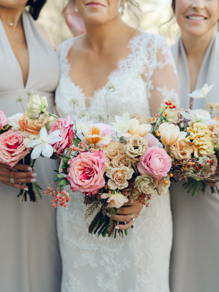 Whimsical bridal bouquet in unique fall tones caramel, dusty rose, peach, tangerine, and copper. Fall floral bouquet with roses, ranunculus, mums, fruiting branches, and clematis. Medium sized bridal bouquet with fall colors. Destination wedding outside Nashville, TN. Design by Rosemary & Finch Floral Design in Nashville, TN. 