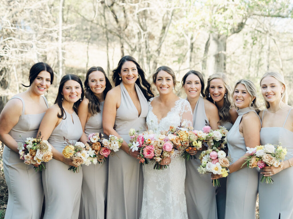 Whimsical bridesmaids’ bouquets in unique fall tones caramel, dusty rose, peach, tangerine, and copper. Fall floral bouquet with roses, ranunculus, mums, fruiting branches, and clematis. Medium sized bridal bouquet with fall colors. Destination wedding outside Nashville, TN. Design by Rosemary & Finch Floral Design in Nashville, TN. 