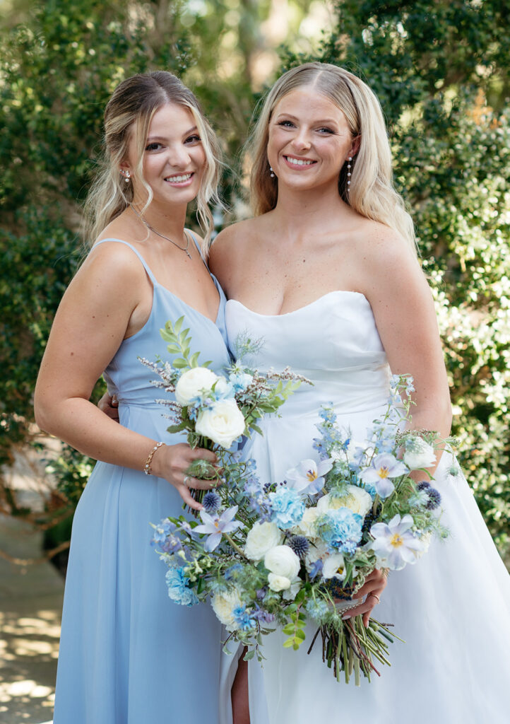 Whimsical bridal bouquet for summer wedding in blue and white. Garden-inspired bridal bouquet consisting or roses, blue tulips, nandina, carnations, ranunculus, and echinops. Medium-sized bridal bouquet for summer wedding. Design by Rosemary & Finch Floral Design in Nashville, TN. 