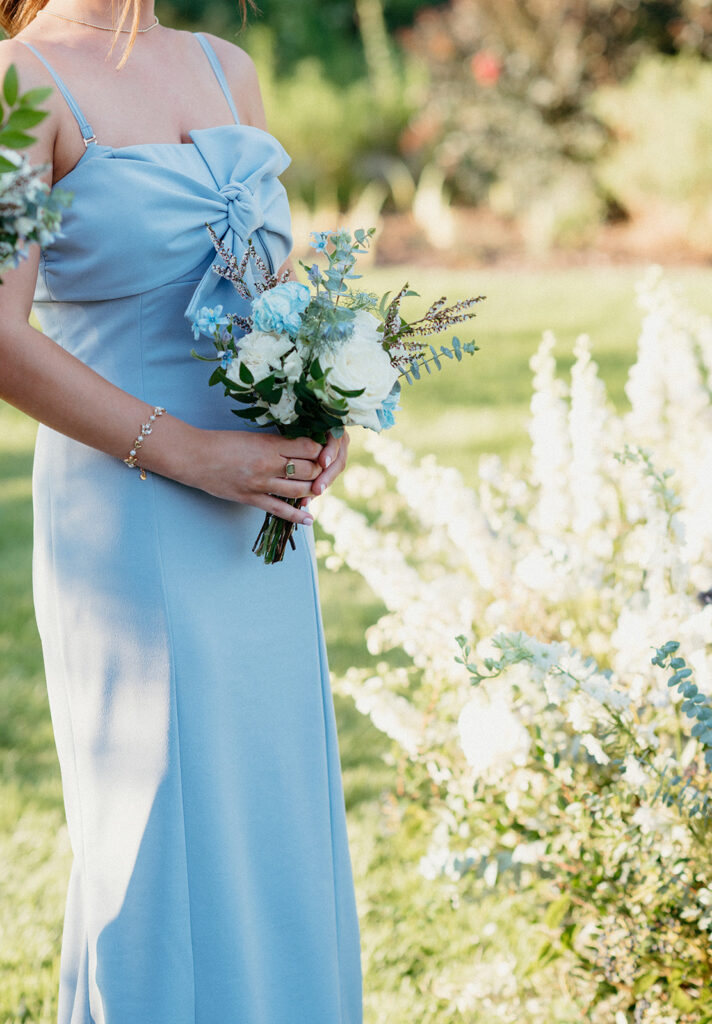 Dainty bridesmaids’ bouquet for summer wedding in blue and white. Garden-inspired bridesmaids’ bouquets consisting or roses, blue tulips, nandina, carnations, ranunculus, and echinops. Design by Rosemary & Finch Floral Design in Nashville, TN. 