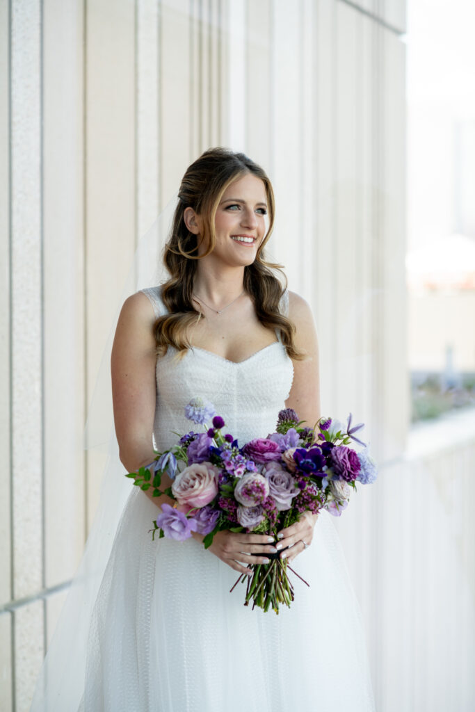 Elegant and whimsical bridal bouquet for fall wedding. Unique purple bridal bouquet with hints of cream, blush, and lavender. Lavender and purple color scheme for fall wedding at the Four Seasons Hotel. Floral colors in lavender, blush, mauve, and rose. Dainty wildflower bridal bouquet. Design by Rosemary & Finch Floral Design in Nashville, TN. 