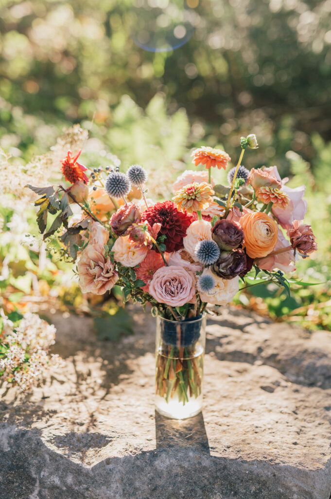 Fall bridal bouquet with local wildflowers. Timeless fall wedding colors for outdoor wedding in September with touches of gold. Fall floral colors with touches of pink, golden yellow, blue, and burgundy. Fall wildflowers for outdoor wedding in Tennessee. Local fall flowers of zinnias, dahlias, and roses for fall wedding. Design by Rosemary & Finch Floral Design in Nashville, TN