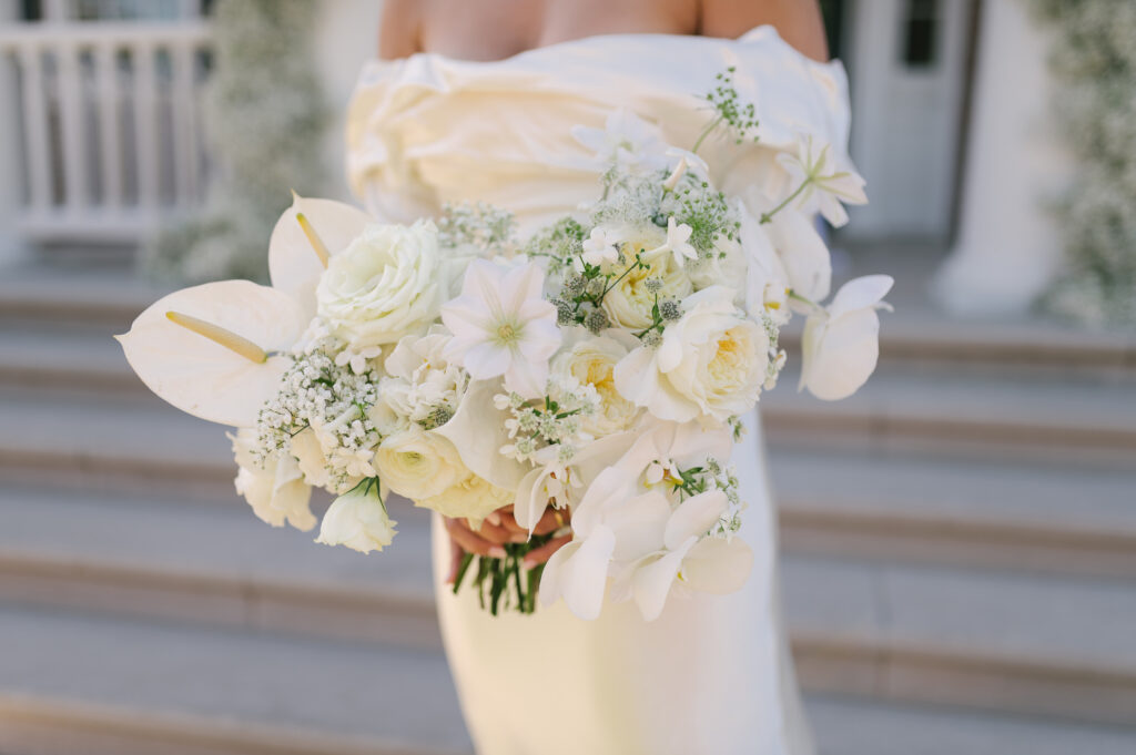 Modern bridal bouquet with all white florals. Classic bridal bouquet with babies’ breath, roses, and orchids. Modern twist on fall wedding with white, taupe, and black color scheme. Fall private estate wedding in Tennessee. Design by Rosemary & Finch Floral Design. 