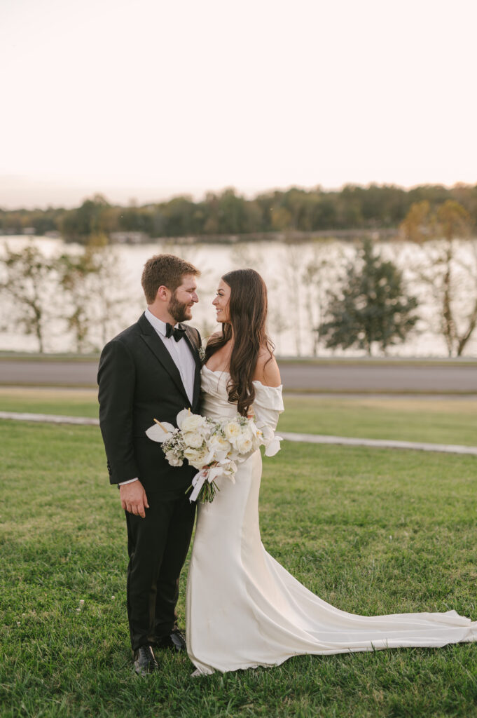 Modern bridal bouquet with all white florals. Classic bridal bouquet with babies’ breath, roses, and orchids. Modern twist on fall wedding with white, taupe, and black color scheme. Fall private estate wedding in Tennessee. Design by Rosemary & Finch Floral Design. 
