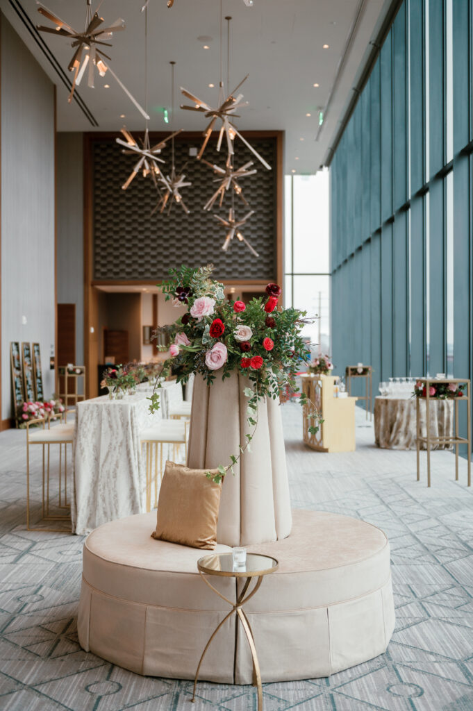 Cocktail hour florals for winter wedding. Moody jewel tone wedding reception florals in ruby, blush, plum, and magenta. Bar menu floral meadows for wedding reception bar. Escort Display mirrors with floral meadows. Unique floral touches in cocktail reception of winter wedding in downtown Nashville. Design by Rosemary & Finch Floral Design.