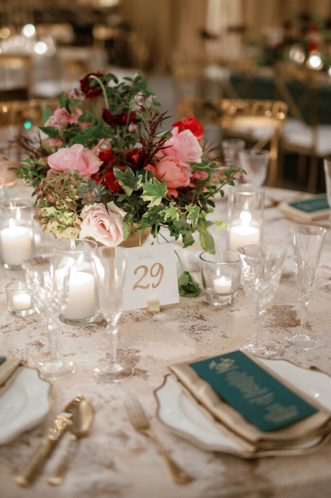 Floral forward low centerpieces for winter wedding. Jewel tone winter wedding color palette. Destination floral design in Nashville, TN. Winter floral colors in ruby, blush, plum, and magenta. Design by Rosemary & Finch Floral Design.