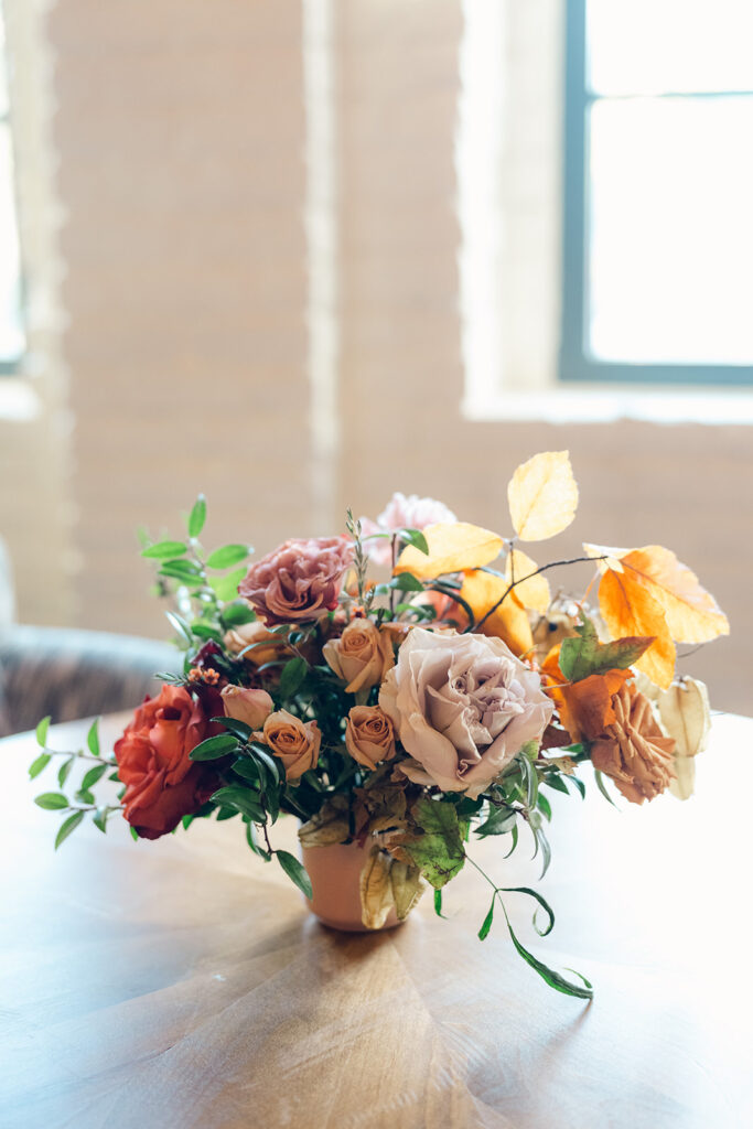 Wedding welcome party florals for fall wedding. Fall floral colors in rust, burgundy, sage, cream, and copper. Charming boho style party at Soho House Nashville. Accent centerpieces in ceramic vessels and glass bud vases decorate fall wedding welcome party in Nashville, Tennessee. Design by Rosemary & Finch Floral Design in Nashville, TN. 