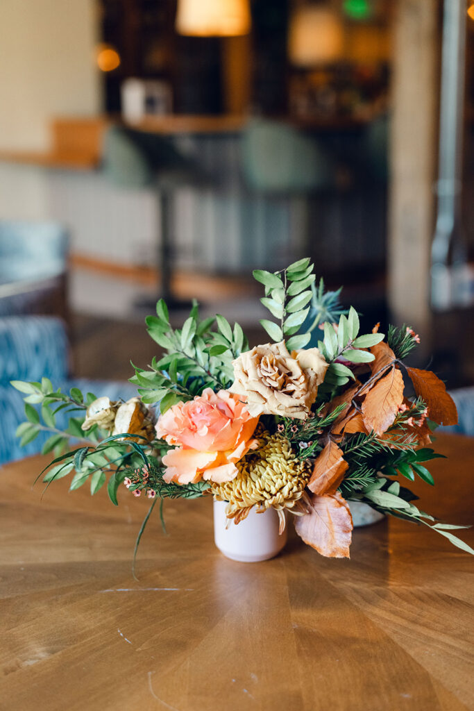 Wedding welcome party florals for fall wedding. Fall floral colors in rust, burgundy, sage, cream, and copper. Charming boho style party at Soho House Nashville. Accent centerpieces in ceramic vessels and glass bud vases decorate fall wedding welcome party in Nashville, Tennessee. Design by Rosemary & Finch Floral Design in Nashville, TN. 