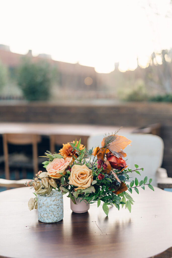 Wedding welcome party florals for fall wedding. Fall floral colors in rust, burgundy, sage, cream, and copper. Charming boho style party at Soho House Nashville. Accent centerpieces in ceramic vessels and glass bud vases decorate fall wedding welcome party in Nashville, Tennessee. Design by Rosemary & Finch Floral Design in Nashville, TN. 