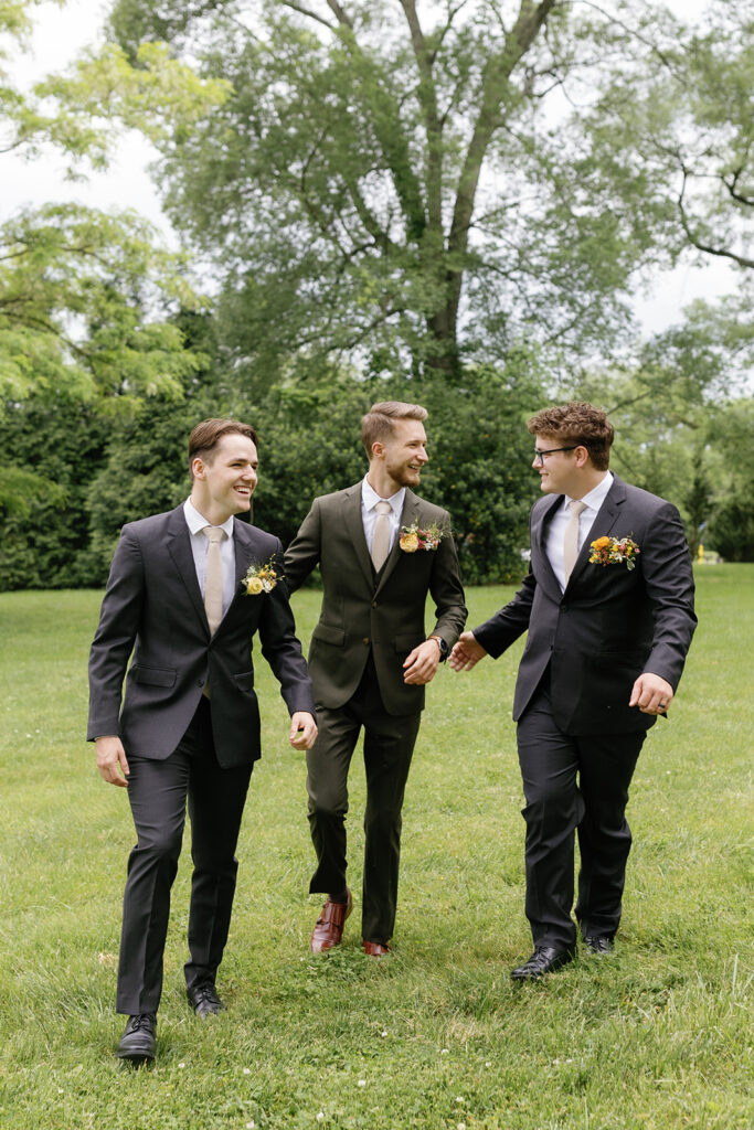 Fun boutonniere alternative for groom. Pocket square boutonniere in fun spring colors. Spring wedding reception with vibrant florals in magenta, yellow, orange, and natural greenery. Design by Rosemary & Finch Floral Design in Nashville, TN. 