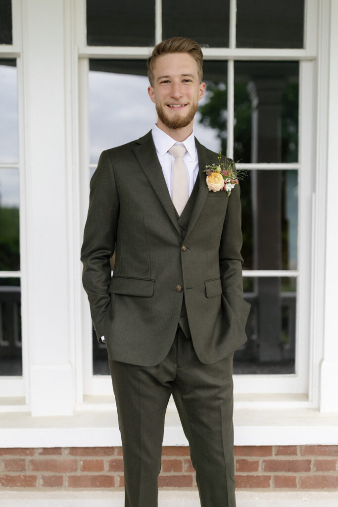 Fun boutonniere alternative for groom. Pocket square boutonniere in fun spring colors. Spring wedding reception with vibrant florals in magenta, yellow, orange, and natural greenery. Design by Rosemary & Finch Floral Design in Nashville, TN. 