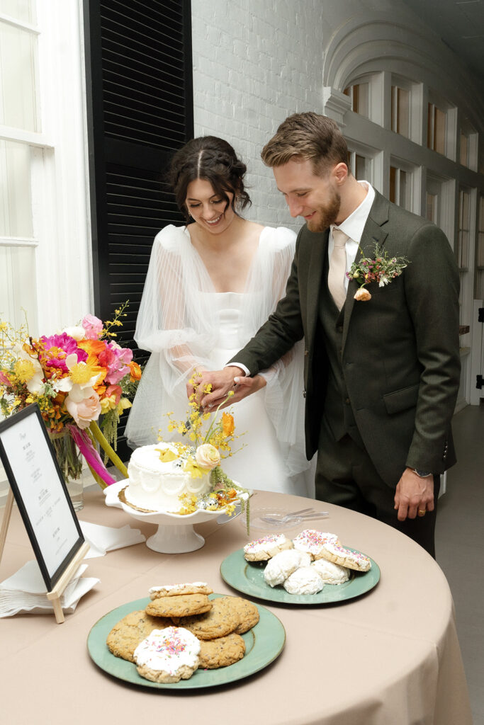 Wedding reception cake with funky floral design. Spring wedding florals with bold color and unique design. Retro disco wedding design creating a playful wedding reception atmosphere. Design by Rosemary & Finch Floral Design in Nashville, TN.