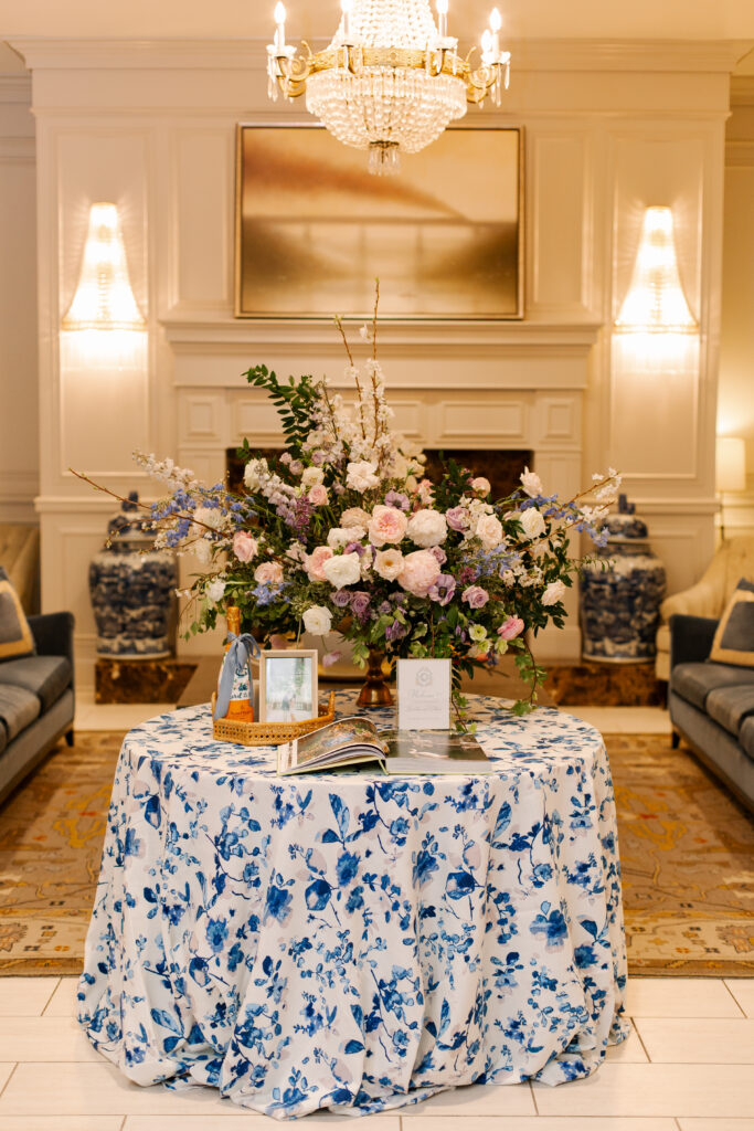 Statement welcome arrangement with lush petal heavy blooms including peonies, roses, ranunculus, and anemones. Garden inspired spring wedding in Nashville, TN. Pastel color palette for spring wedding which shades of pink, purple, lavender, and cream. Design by Rosemary & Finch Floral Design in Nashville, TN. 