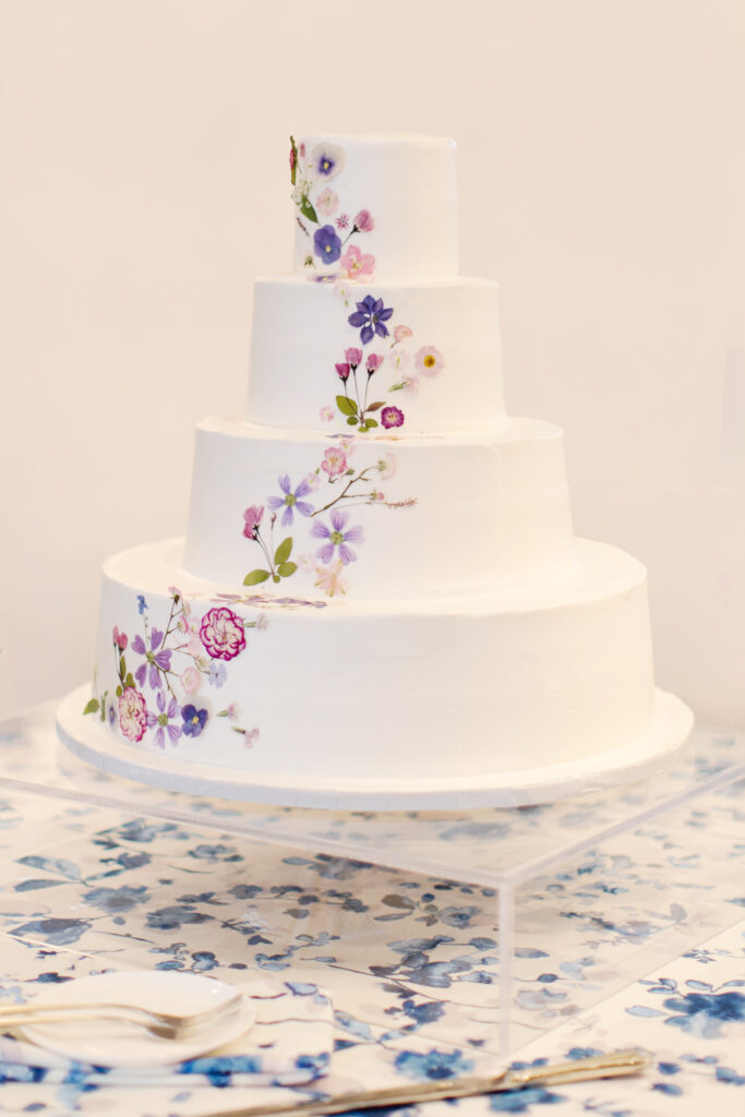 Hand pressed flowers for wedding reception cake. Spring floral design with pastel color palette and garden-inspired design. Unique florals for wedding cake. Design by Rosemary & Finch Floral Design in Nashville, TN. 