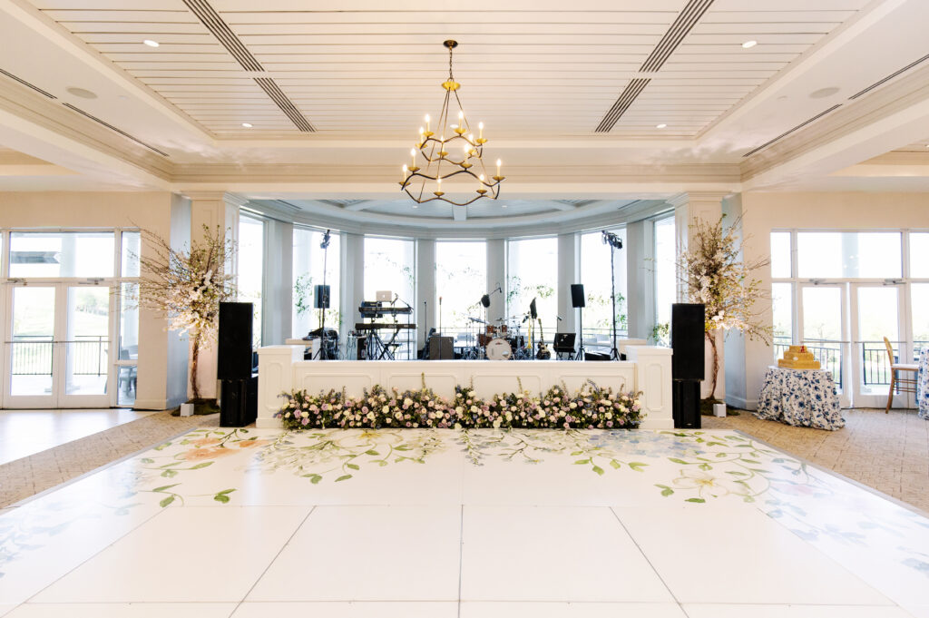 Lush and low floral meadows grow to accent the reception space of this spring wedding. Pastel color palette for spring wedding which shades of pink, purple, lavender, and cream. Mix of roses, peonies, and other delicate blooms, accented with greenery. Design by Rosemary & Finch Floral Design.