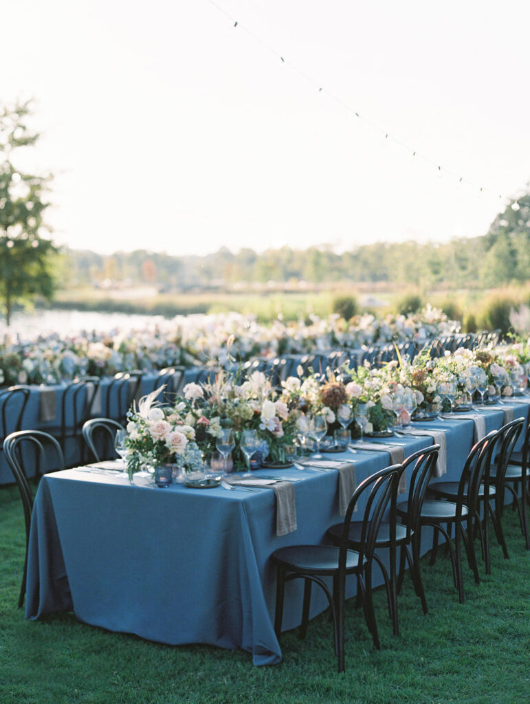 Lush floral table runner for fall wedding reception. Outdoor wedding reception at Southall Farm & Inn in Tennessee. Soft whimsical floral design for unique fall wedding design. Fall wedding color palette in brown, soft blue, dusty rose, and muted greens. Whimsical florals featuring dried hydrangeas, tulips, delphinium, and grasses. Design by Rosemary & Finch Floral Design in Nashville, TN. 